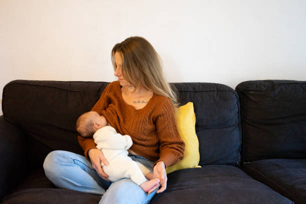 a calm mother breastfeeding her baby